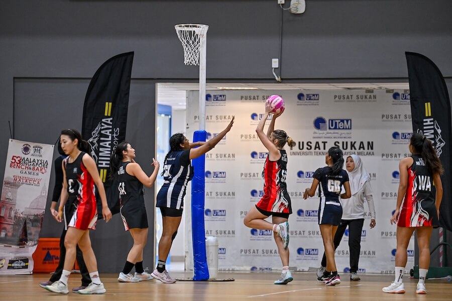 A group of women playing basketball